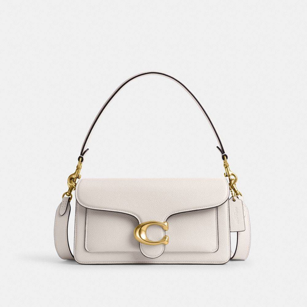Why does the Coach Tabby Shoulder Bag 26 cost so much less in US stores compared to New Zealand boutiques?